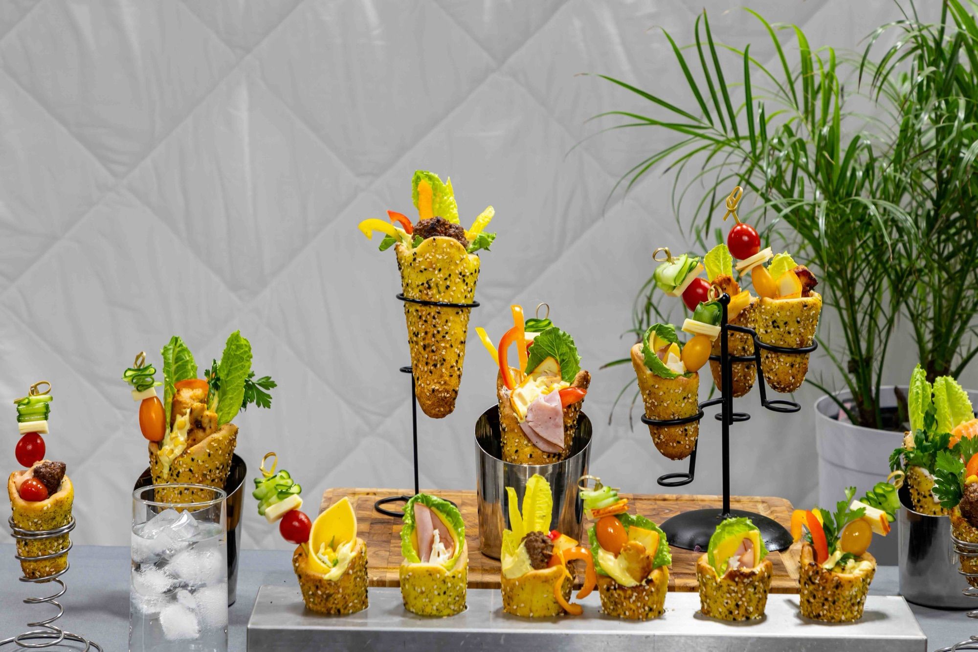 A buffet station of filled mini BreadKones on tiered wire stands and skewers