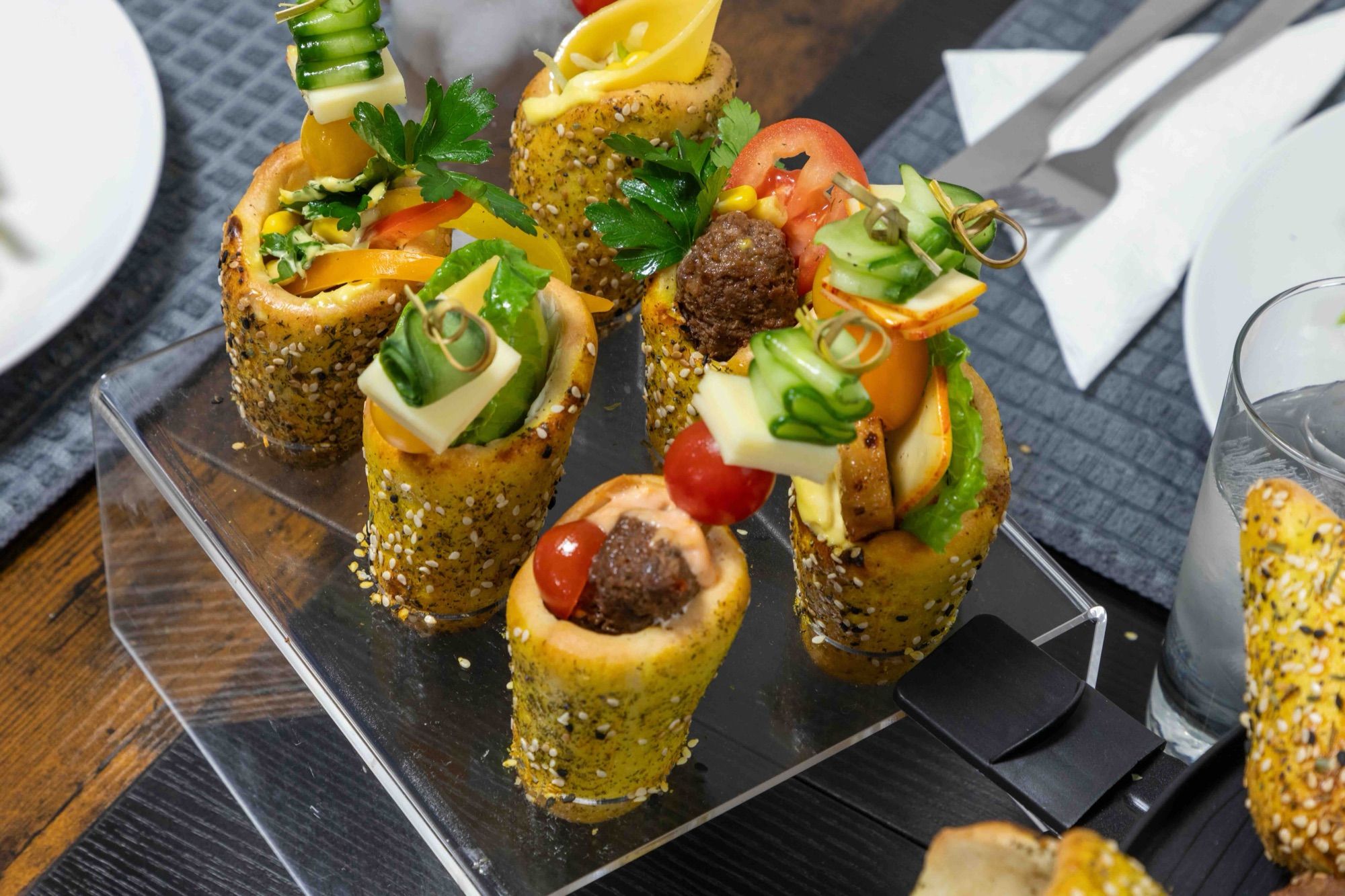 Mini BreadKones on an acrylic stand at a plated dinner setting
