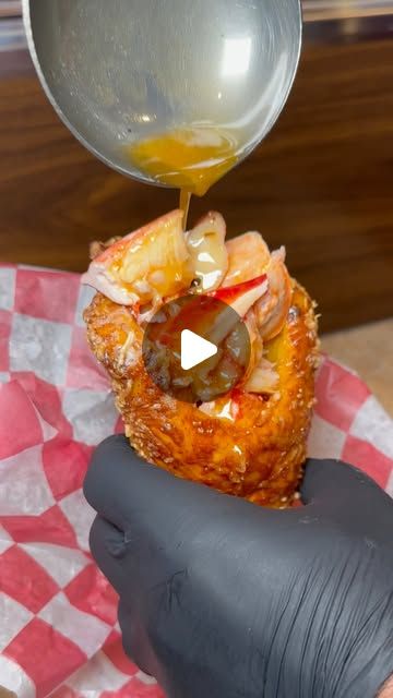 Melted butter poured over a lobster-filled garlic bread cone